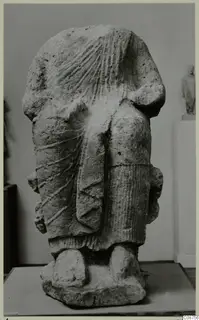Back view of a Neo-Cypriote limestone statue of a standing figure