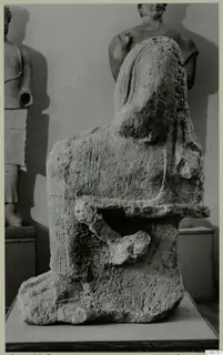 Neo-Cypriote limestone statue fragment with a rounded head, broken arm and rough, weathered surface