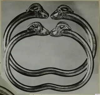 Two gold bracelets from Vouni with ram-head terminals, overlapping and facing each other in pairs