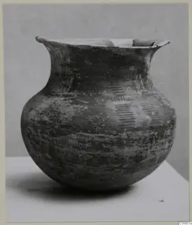 Round-bodied pot with a flaring neck and small handles at the rim, painted with hatched motifs on the upper body.