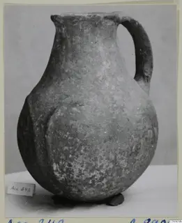 Pottery Monochrome Ware jug with a single handle, photographed on a white surface against a grey backdrop