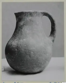 Pottery Monochrome Ware jug with a single strap handle, shown on a white surface