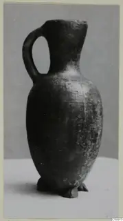Pottery jug with one loop handle, Pottery Red Lustrous Ware, photographed against a grey backdrop
