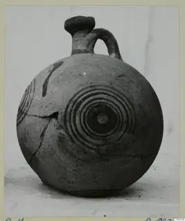 Round jug with a single loop handle and concentric circles painted on its body, shown against a plain background.