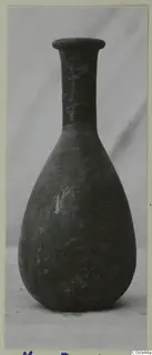 Pottery bottle with a long narrow neck, flared rim and pear-shaped body, photographed upright.