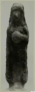 Standing terracotta figurine with arms bent across the chest, seen from the front against a grey backdrop.