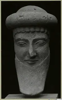 Limestone head of a figure wearing a wide cap, from Idalion