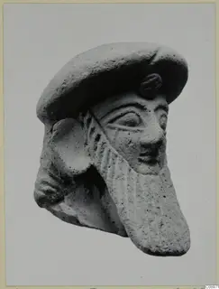 Terracotta head of a bearded figure from Vasilika, wearing a flat cap, shown in three-quarter view