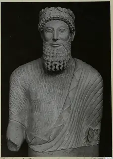 Carved limestone bust of a bearded man with a leafy wreath, from Arsos VII in the British Museum