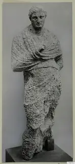 Standing draped statue from Mersinaki, carved in pitted pale stone, with a cloth mantle over the shoulders and arms