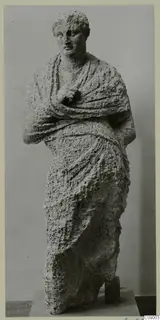 Standing draped statue in pale, porous stone, from Mersinaki