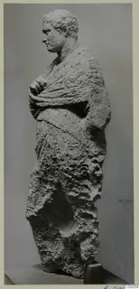 Limestone statue of a standing male figure in a draped cloak, from Mersinaki