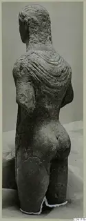 Back view of a limestone statue of a standing man from Mersinaki