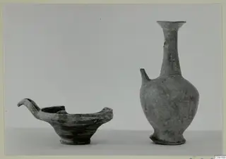 Pottery Base-Ring Ware: a shallow bowl with a curved spout-handle and a juglet with a tall flaring neck