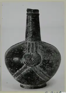 Base-Ring Ware bottle-shaped vessel with a long neck, concentric-circle relief and rope-moulded bands on the body