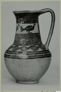 Jug with a strap handle, painted with birds, spirals and dark bands
