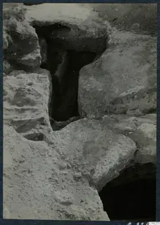Excavated stone-lined opening with dark cavity at the palace at Vouni