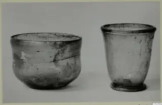 Two blown glass beakers photographed side by side on a plain background