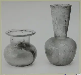 Two blown glass vessels side by side: a squat jar with a flared rim and a flask with a tall funnel neck