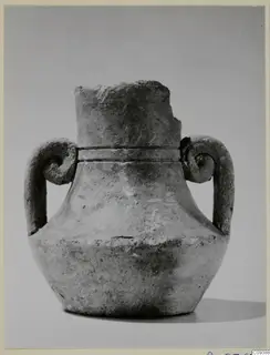 Pot with two spiral handles and a broken neck, photographed against a plain grey backdrop