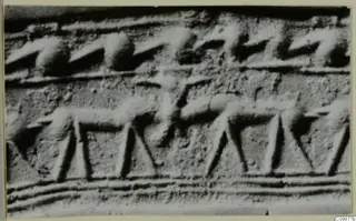 Close-up of an engraved surface showing a row of four-legged animal figures in a band