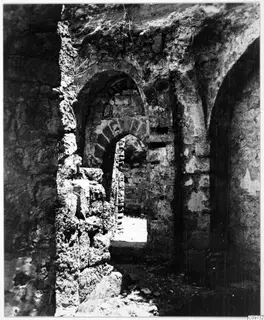 Ruined stone walls and arched openings with loose stones on the ground, Kyrenia Mountains
