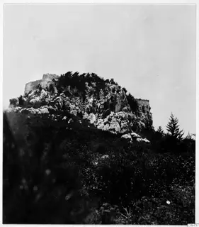 Rocky hilltop in the Kyrenia Mountains, with ruined walls along its summit and trees growing among the rocks