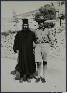 Papa Polivios and Einar Gjerstad standing side by side on a dirt road in Mandres, Ayios Iakovos