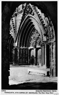 Central west doorway of St Nicholas cathedral, Famagusta, with a pointed arch, carved mouldings and tall wooden doors