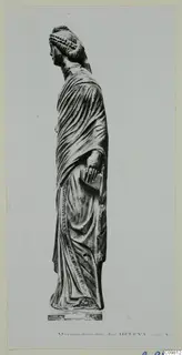 Mounted photograph of a standing stone statue of a draped female figure, seen in profile with the head turned left.