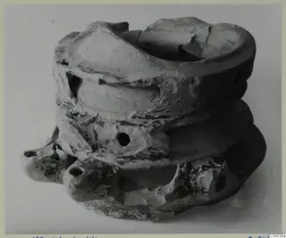 Terracotta lamp from Mersinaki, several rounded lamp bodies stacked together with a broken rim