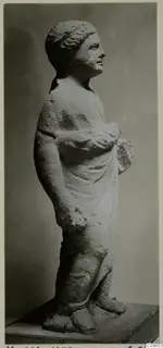Standing draped statue from Mersinaki, shown in side view on a wooden base