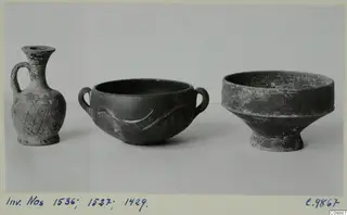 Three pottery vessels: a small jug and two bowls, photographed side by side against a grey backdrop