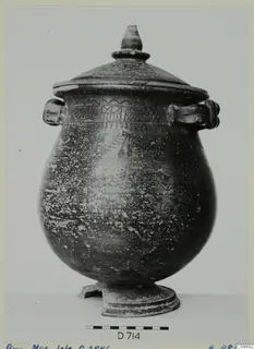 Lidded two-handled vessel with a dark surface and bands of painted geometric decoration, seen from the side