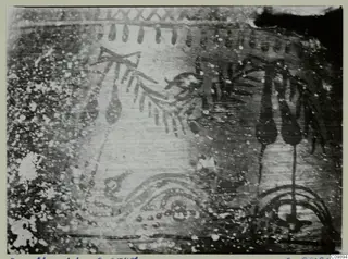 Close photograph of a painted find surface with dark motifs of sprays, drops and arcs, and a possible bird-like figure