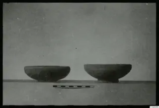 Two pottery bowls side by side on a grey surface, with a scale bar in front, from Ajii Omologitades, Politiko and Limassol Oasis