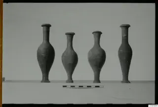 Four narrow-necked vessels with flared rims standing in a row, from Ajii Omologitades, Politiko and Limassol Oasis