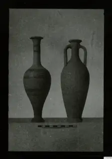 Two pottery vessels side by side, a tall one with painted bands and a two-handled jar, with a scale bar in front