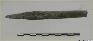 Long pointed implement, dark and corroded, shown horizontally with a scale bar, from Ajii Omologitades, Politiko T1914 and Limassol Oasis T1