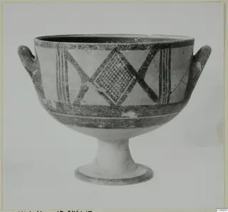 White Painted II pottery bowl on a high foot, with two handles and dark painted bands and lattice motifs.