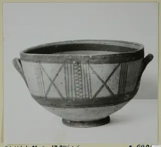 Pottery White Painted III-1 bowl with two small handles, dark painted bands and crossed and vertical line patterns