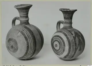 Two White Painted I jugs with banded and concentric circle decoration, shown side by side.
