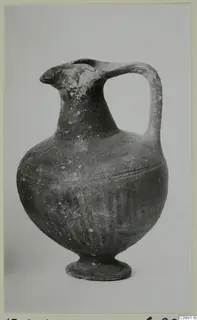 Pottery jug from the Black Slip group, with a strap handle, pinched spout and ring base
