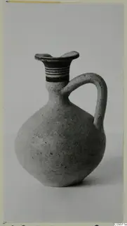 Juglet with a single loop handle, a flaring rim and bands of paint on the neck.