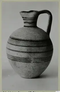 White Painted III-1 jug with a single loop handle and dark painted bands around its body and neck.