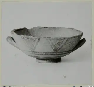 Bichrome II bowl with two small side handles and dark painted bands and triangles, shown from the side
