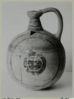 Pottery Bichrome V jug with a single loop handle and painted concentric bands