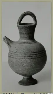 White Painted III jug with a strap handle, side spout and ring foot