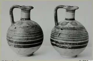 Two jugs with strap handles and banded decoration, standing side by side