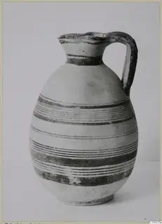 White Painted IV jug with a single loop handle and dark painted bands on a pale body.